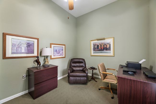 Carpeted office with baseboards, a ceiling fan, and high vaulted ceiling | Image 28