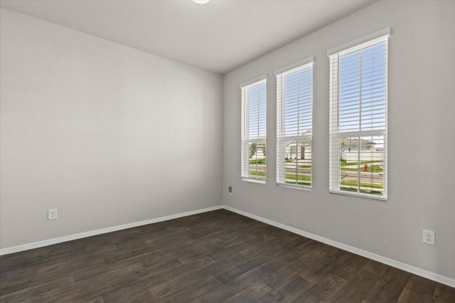 Empty room featuring baseboards and dark wood-style floors | Image 5