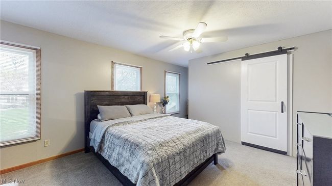 PRIMARY BEDROOM WITH SLIDING DOOR TO WALK IN CLOSET. | Image 21