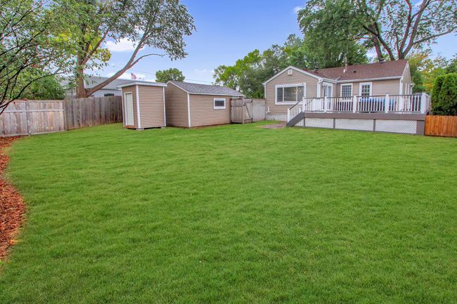 Large fenced in backyard with a shed | Image 22