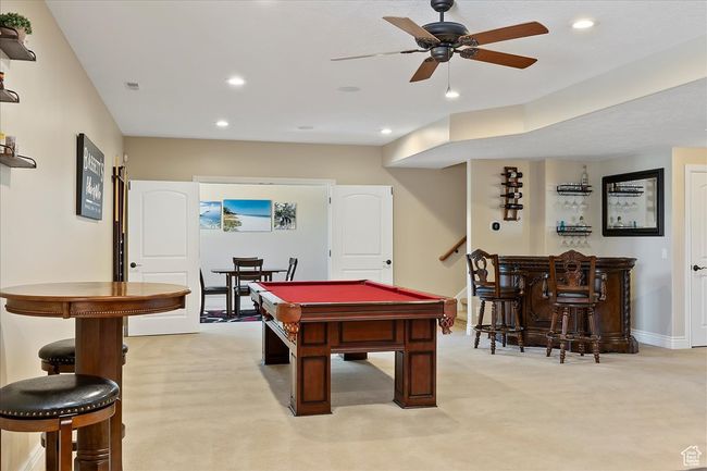 Rec room with baseboards, billiards, light colored carpet, recessed lighting, and a dry bar | Image 20