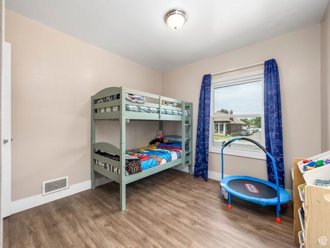 Bedroom featuring baseboards and wood finished floors | Image 10