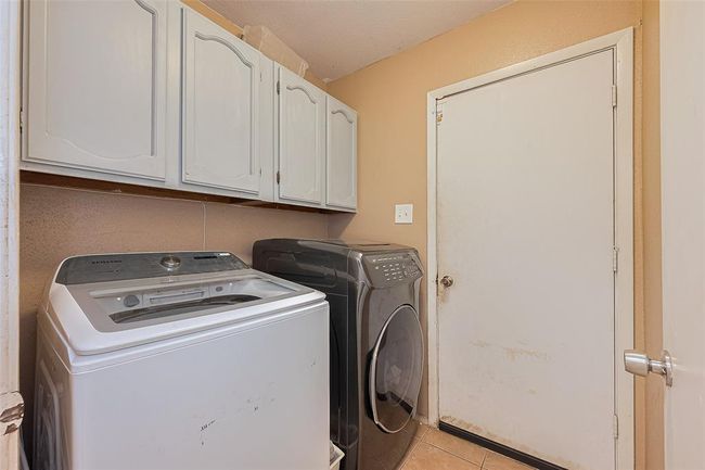Laundry room with built in cabinets. located next to garage and primary bedroom. | Image 19