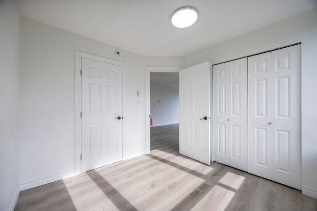 Unfurnished bedroom featuring wood finished floors and a closet | Image 6