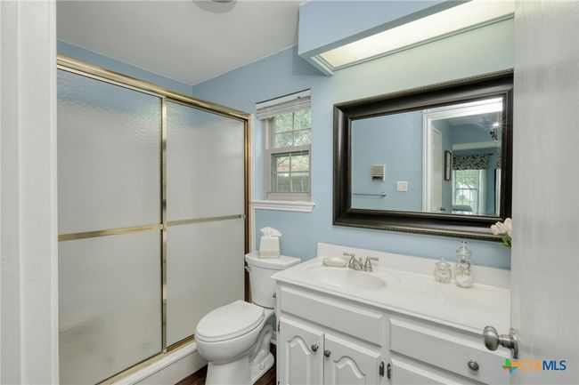 Primary Bathroom downstairs with walk-in shower & separate vanity. | Image 15
