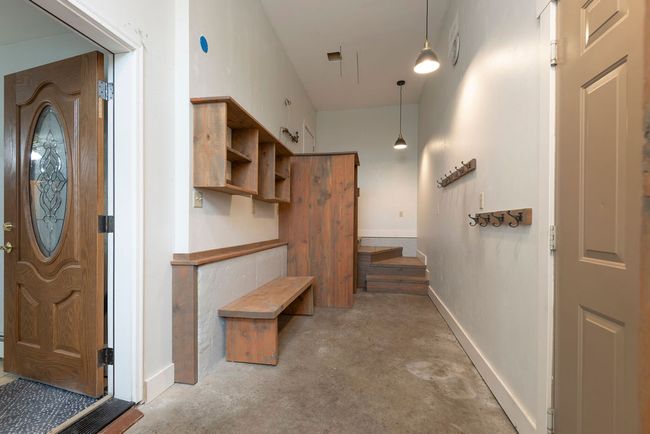 Entrance foyer with unfinished concrete floors and baseboards | Image 23
