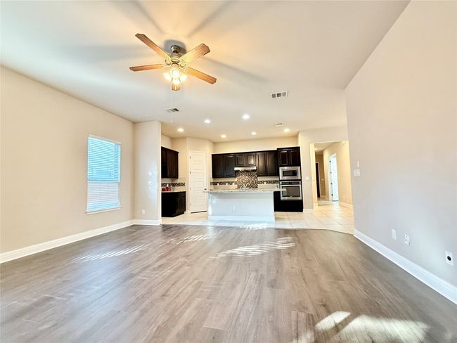 Unfurnished living room featuring recessed lighting, ceiling fan, and light wood finished floors | Image 12