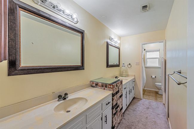 Full bathroom with toilet, visible vents, and vanity | Image 10