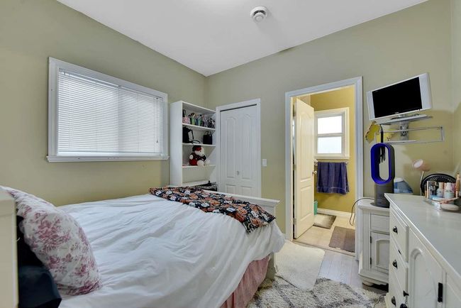 Bedroom with a closet, light wood-style floors, and ensuite bath | Image 33