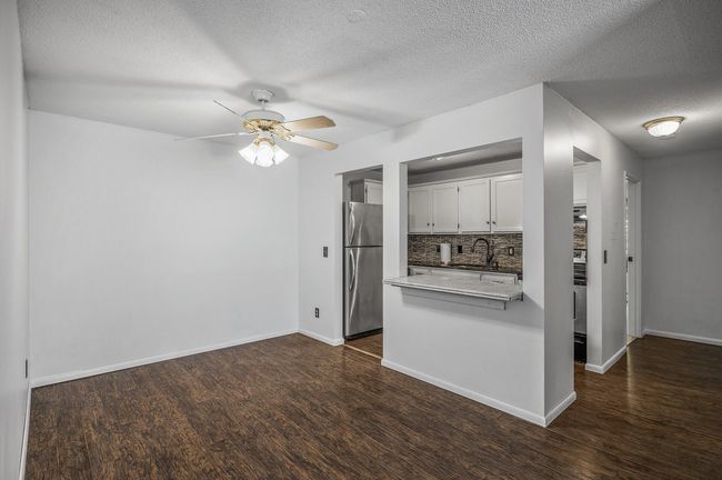 The cozy dining area is ideal for everyday meals and features a ceiling fan for enhanced comfort. | Image 9