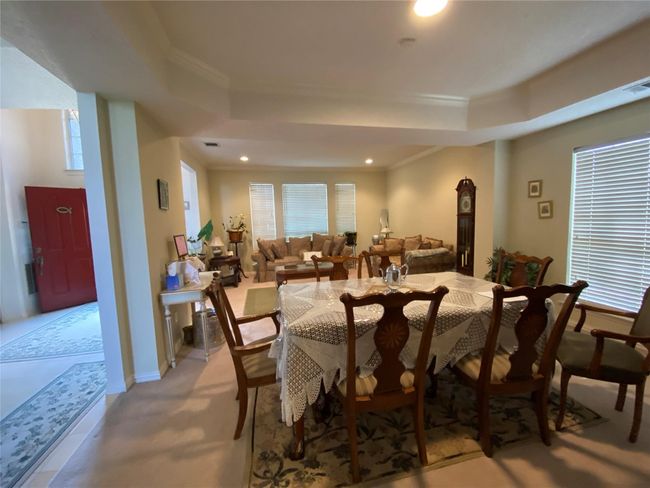 Dining room with a healthy amount of sunlight, a tray ceiling, and crown molding | Image 20