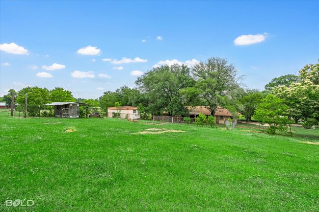 View of yard with an outbuilding and view of wooded area | Image 31