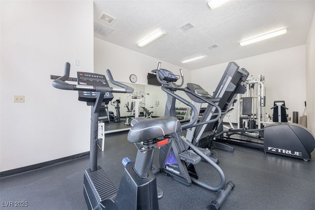 Common Gym featuring a textured ceiling and visible vents | Image 57