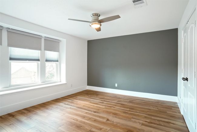 Bedroom #4 featuring hardwood / wood-style flooring and wooden walls | Image 19