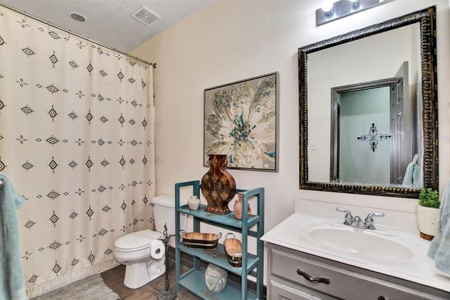 Convenient downstairs guest bathroom with stylish decor. | Image 25