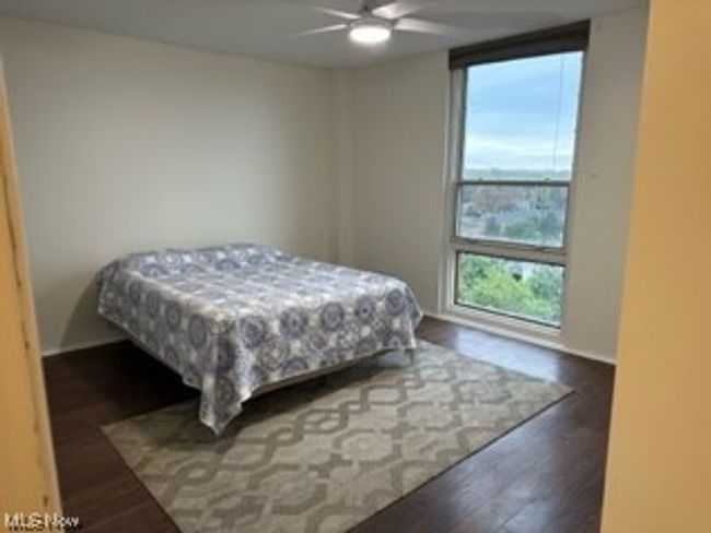 Hardwood floored bedroom with ceiling fan | Image 11