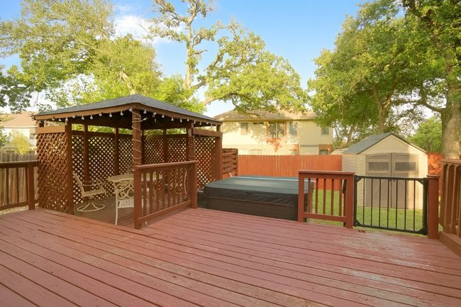 Deck with a storage shed, a fenced backyard, a gazebo, and a covered hot tub | Image 21