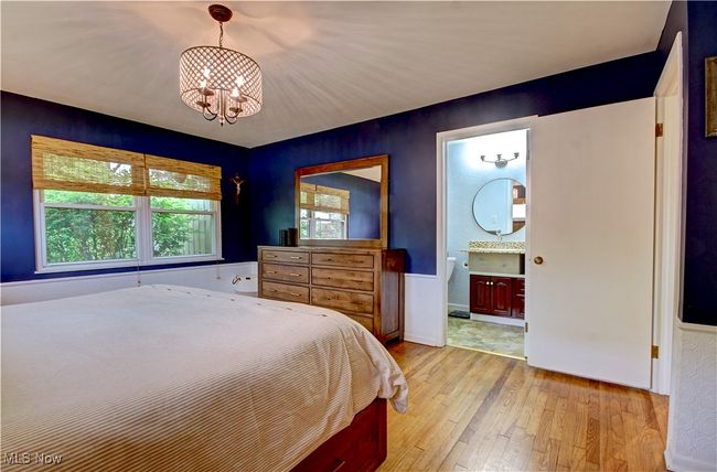 Bedroom with a chandelier, light wood-style flooring, and connected bathroom | Image 25