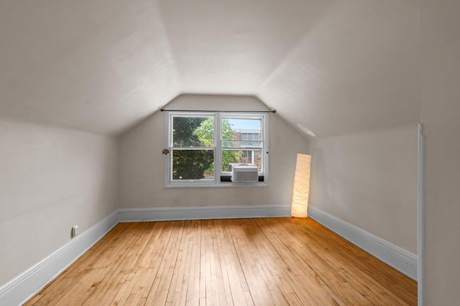Spacious upper-level living room featuring hardwood floors and abundant natural light. | Image 18