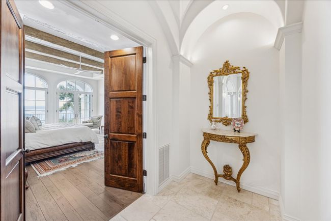The lovely double door entrance to the primary suite offers Segreto finishes. | Image 17