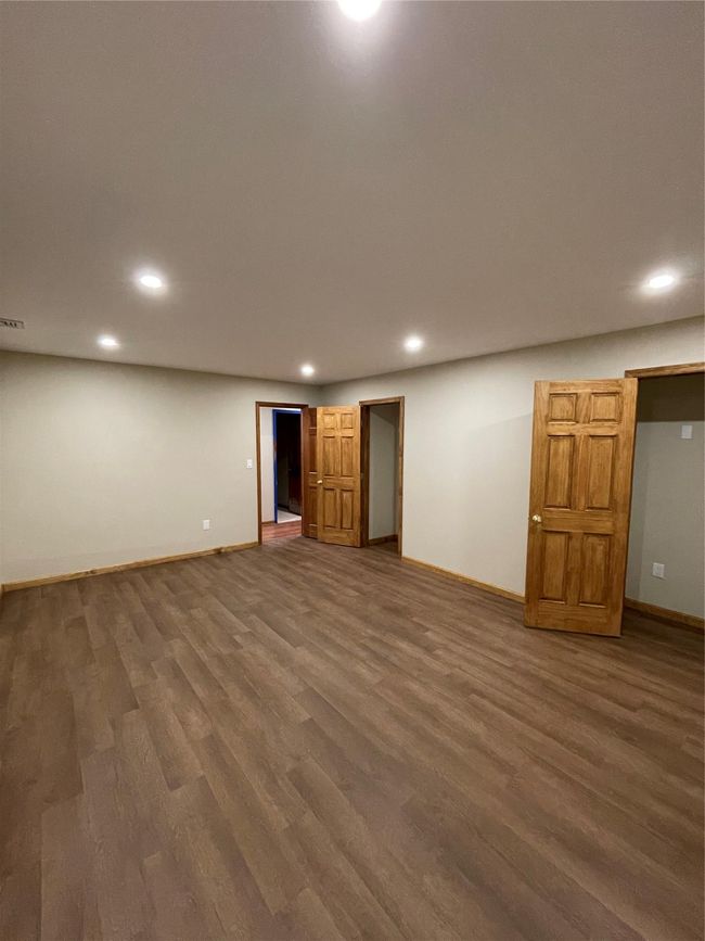 Room with baseboards, wood finished floors, and recessed lighting | Image 5