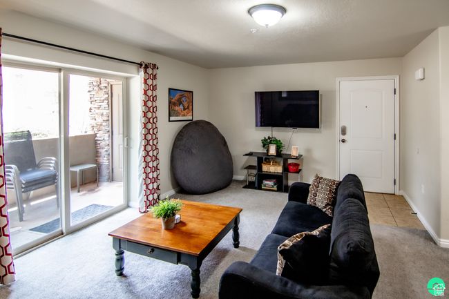 Carpeted living area featuring baseboards | Image 4