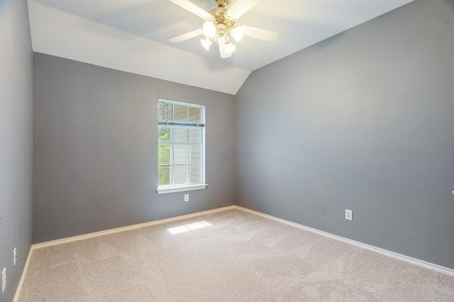 Empty room featuring ceiling fan, carpet flooring, baseboards, and lofted ceiling | Image 19