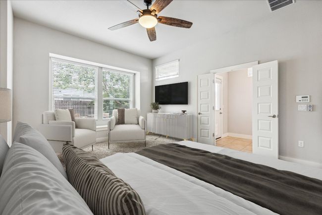 Bedroom featuring baseboards, light tile patterned floors, and ceiling fan | Image 16