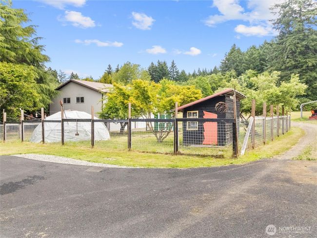 fruit trees, chicken coops, large garden with potting shed, fenced acreage, RV parking, and a creek. | Image 35