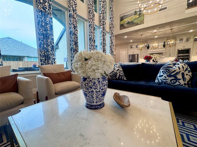 Living area with a chandelier and a towering ceiling | Image 12
