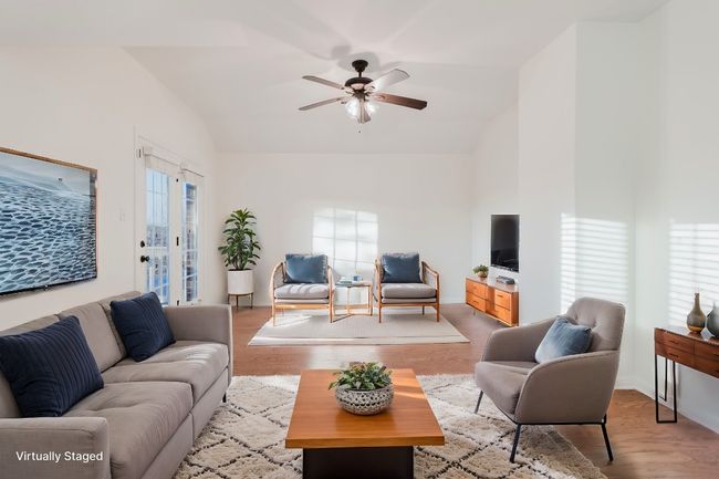 upstairs Living area leading out to balcony, ceiling fan, and wood finished floors | Image 18