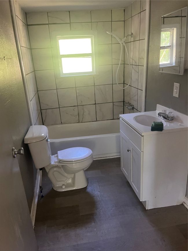Full bathroom with vanity, toilet, wood finished floors, and shower / bath combination | Image 13