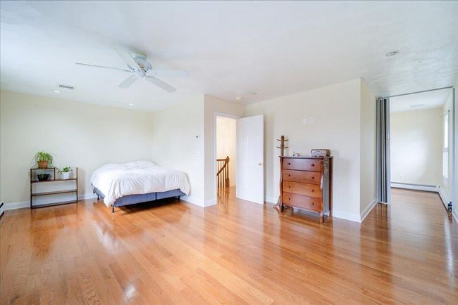 Bedroom featuring visible vents, baseboards, light wood-type flooring, and ceiling fan | Image 20