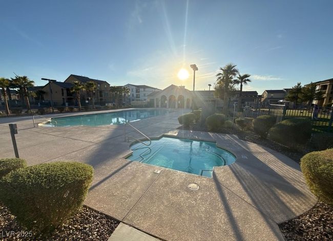 Pool with fence, a hot tub, and a patio | Image 13