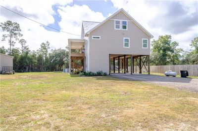 Back of house with a yard and a carport | Image 3