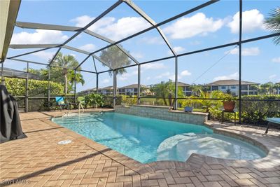 View of swimming pool featuring a patio area and a lanai | Image 2