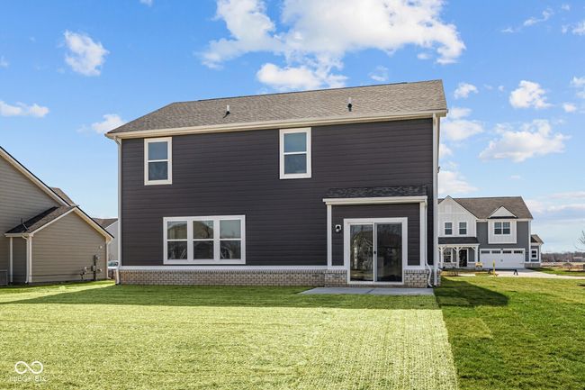 back of house featuring a lawn | Image 28