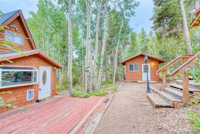 Open courtyard/patio connects main cabin, bonus cabin & garage | Image 2