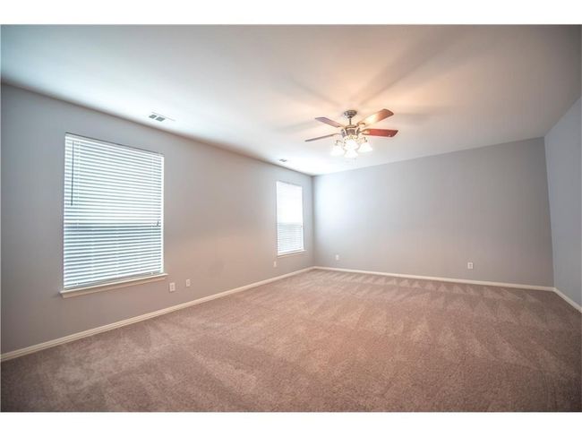 Empty room featuring carpet floors, baseboards, and ceiling fan | Image 14