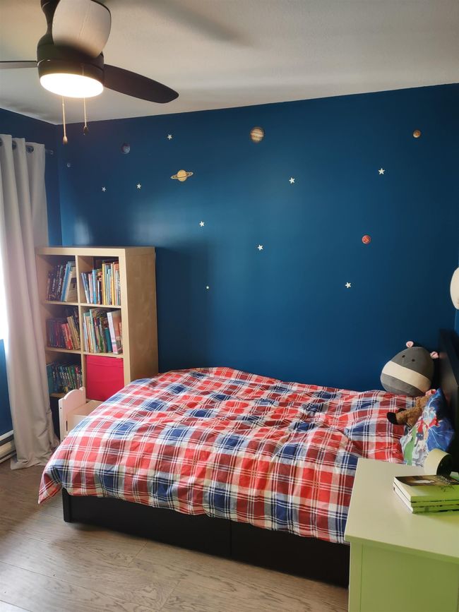 Bedroom featuring a ceiling fan and wood finished floors | Image 17
