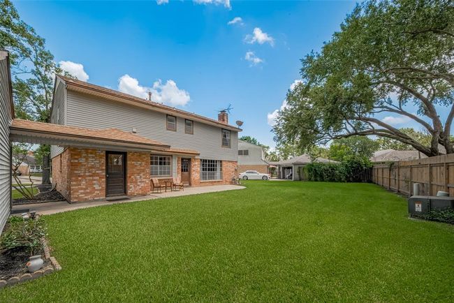 Expansive backyard perfect for relaxation and outdoor activities. | Image 33
