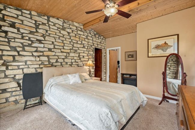 Bedroom with wood ceiling and carpet | Image 14