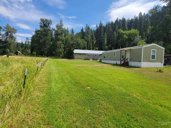 View of yard with a view of trees and entry steps | Image 44