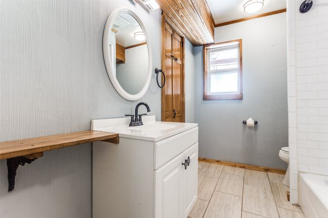 Bathroom featuring vanity, toilet, and a bathtub | Image 33