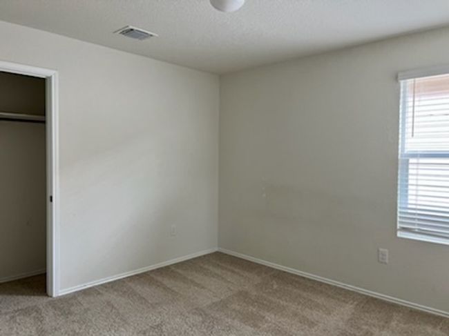 Unfurnished bedroom with carpet floors, a closet, and a textured ceiling | Image 11