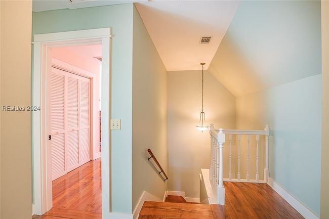 Stairs featuring hardwood / wood-style flooring and lofted ceiling | Image 42