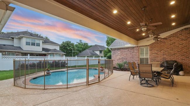 Take a rest from your dip in the pool underneath the large covered patio with tongue and groove ceiling. | Image 39
