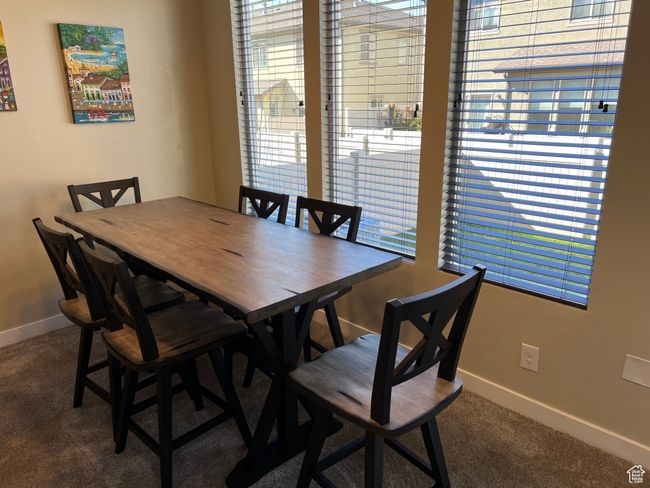 Carpeted dining area featuring baseboards | Image 6