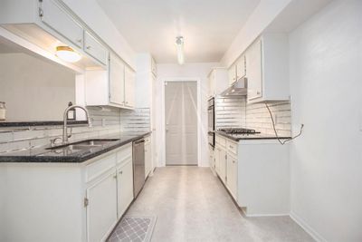 Kitchen with stainless steel appliances, gas cooktop and vent hood. | Image 2