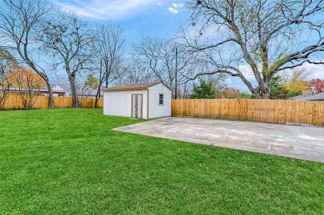 Fenced backyard with an outbuilding and a patio | Image 40